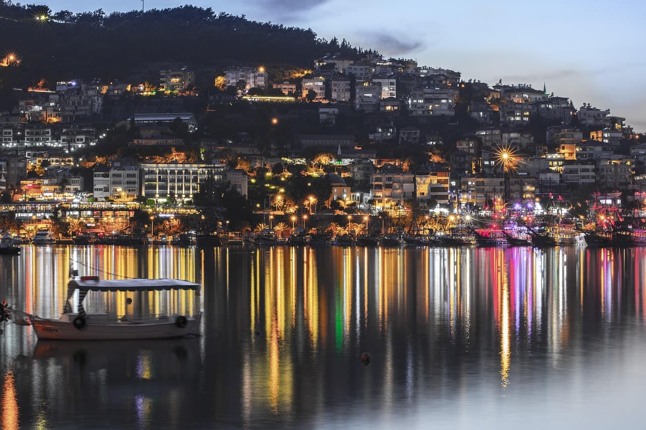 Hillside homes and a harbour at night on Türkiye's southern coast